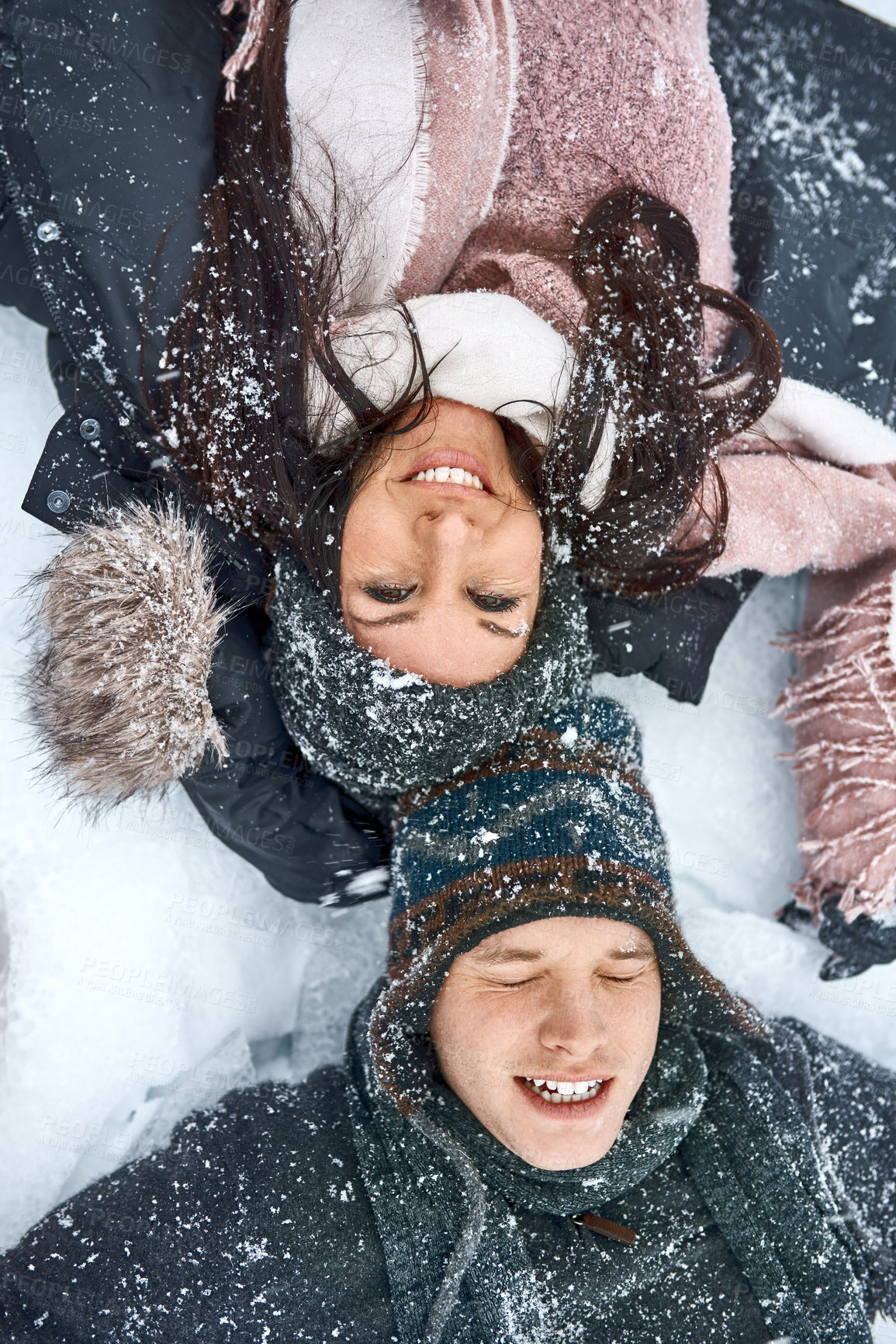 Buy stock photo Couple, happy and playing in snow with travel for winter adventure, exploring nature together and support. People, smile and relax on ground for hiking, trekking and holiday in countryside with care
