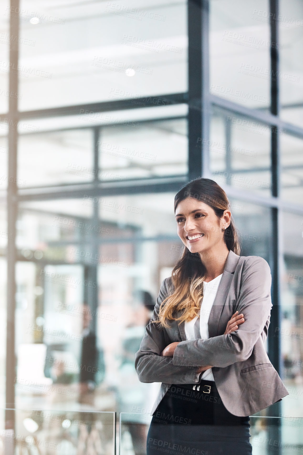 Buy stock photo Shot of a confident young businesswoman working in a modern office