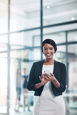 Buy stock photo Portrait of a young businesswoman using a mobile phone in a modern office