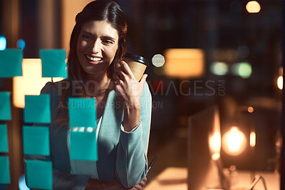 Buy stock photo Shot of a young businesswoman having a brainstorming session at night in a modern office