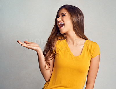 Buy stock photo Happy, woman and hand with presentation in studio for announcement, information and marketing. Female person, smile and excited with mockup space for news, advertising or promotion on gray background