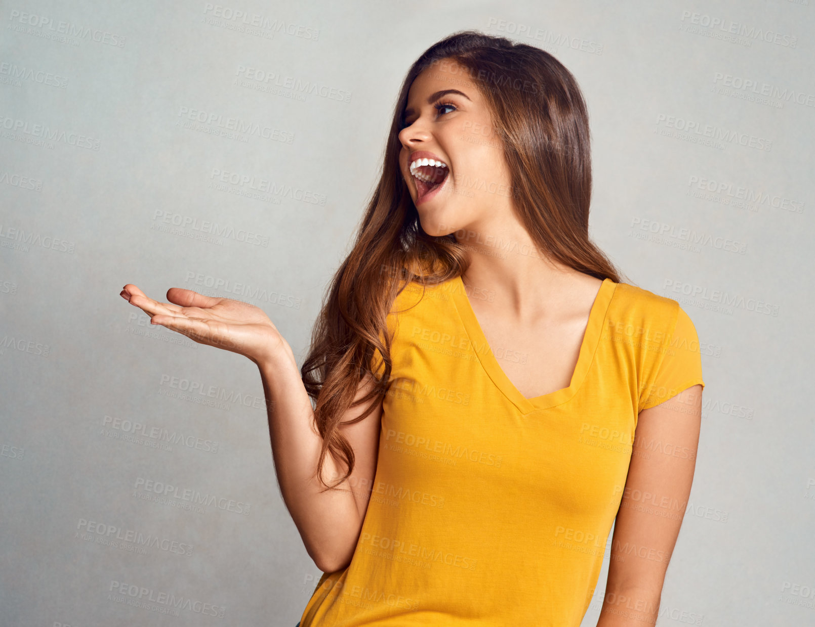 Buy stock photo Happy, woman and hand with presentation in studio for announcement, information and marketing. Female person, smile and excited with mockup space for news, advertising or promotion on gray background