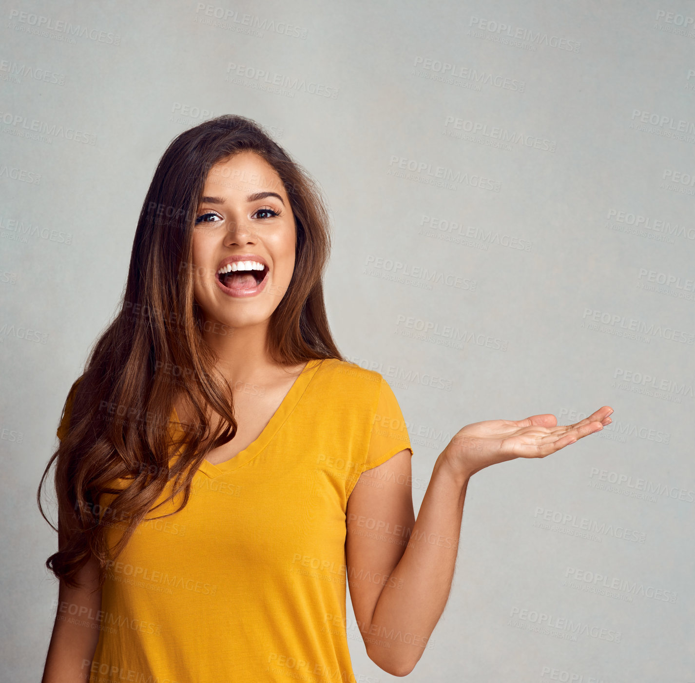 Buy stock photo Portrait, woman and smile with presentation in studio for advertising, information or announcement. Female person, happy and hand with mockup space for marketing, news or promotion on gray background