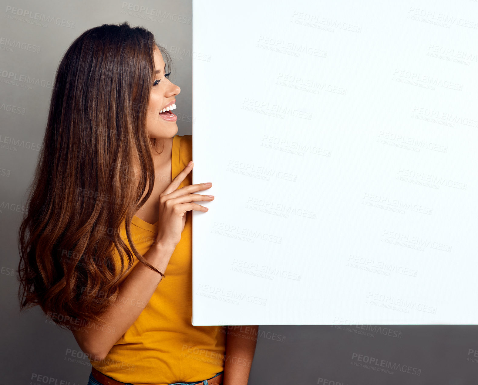 Buy stock photo Happy, woman and thinking with billboard in studio for poster, design and marketing information. Smile, person and paper banner with mockup space for promotion, sign or advertising on gray background