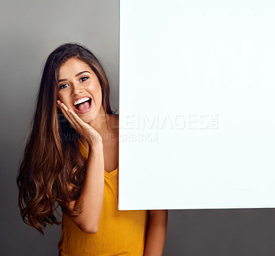 Buy stock photo Poster, surprise and portrait of woman in studio for good news, announcement and information. Happy, advertising and person with sign, bulletin or banner for sale, deal and bargain on grey background