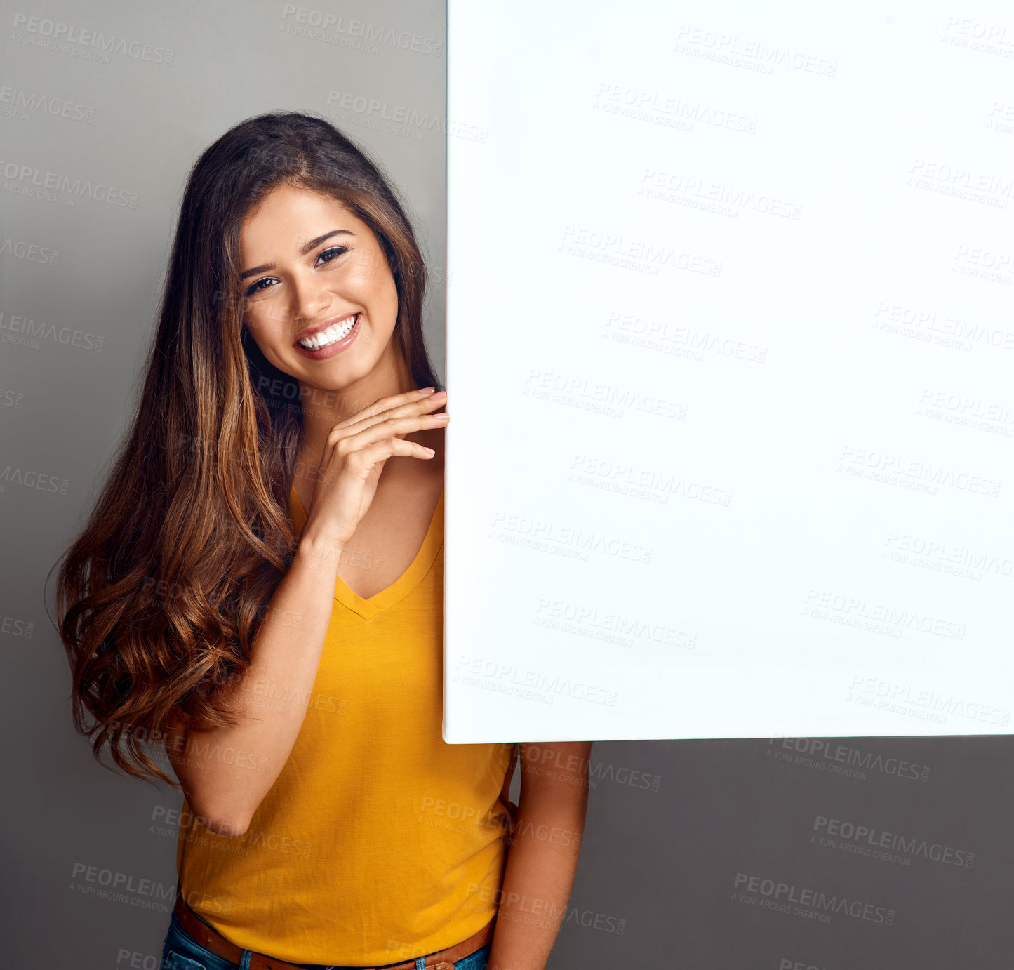 Buy stock photo Happy, woman and portrait with billboard in studio for design, poster and marketing information. Smile, person and mockup space on paper banner for advertising, sign and promotion on gray background