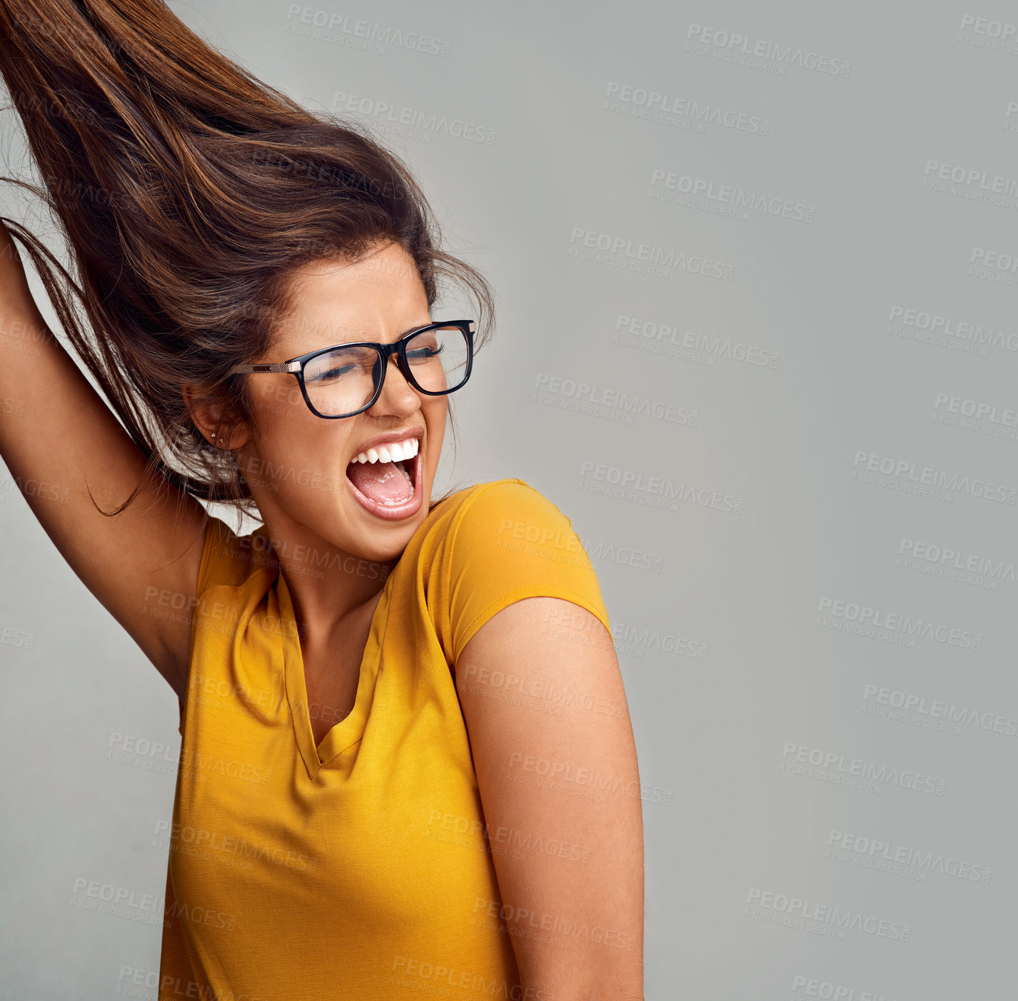 Buy stock photo Excited, glasses and woman with smile, celebration and winning on gray studio background. Person, model and girl with eyewear, cheerful and joyful with victory, success and carefree with confidence 