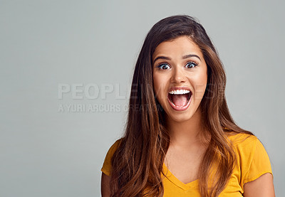 Buy stock photo Studio portrait of an attractive young woman looking surprised against a grey background