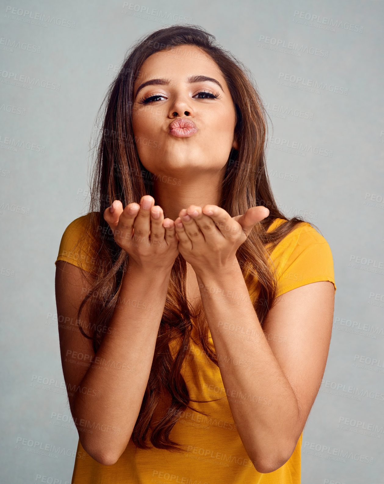Buy stock photo Studio, portrait and woman with kiss for flirting, blow and playful with affection gesture for goodbye. Female model, pout and emoji reaction by gray background for romance, face expression and love