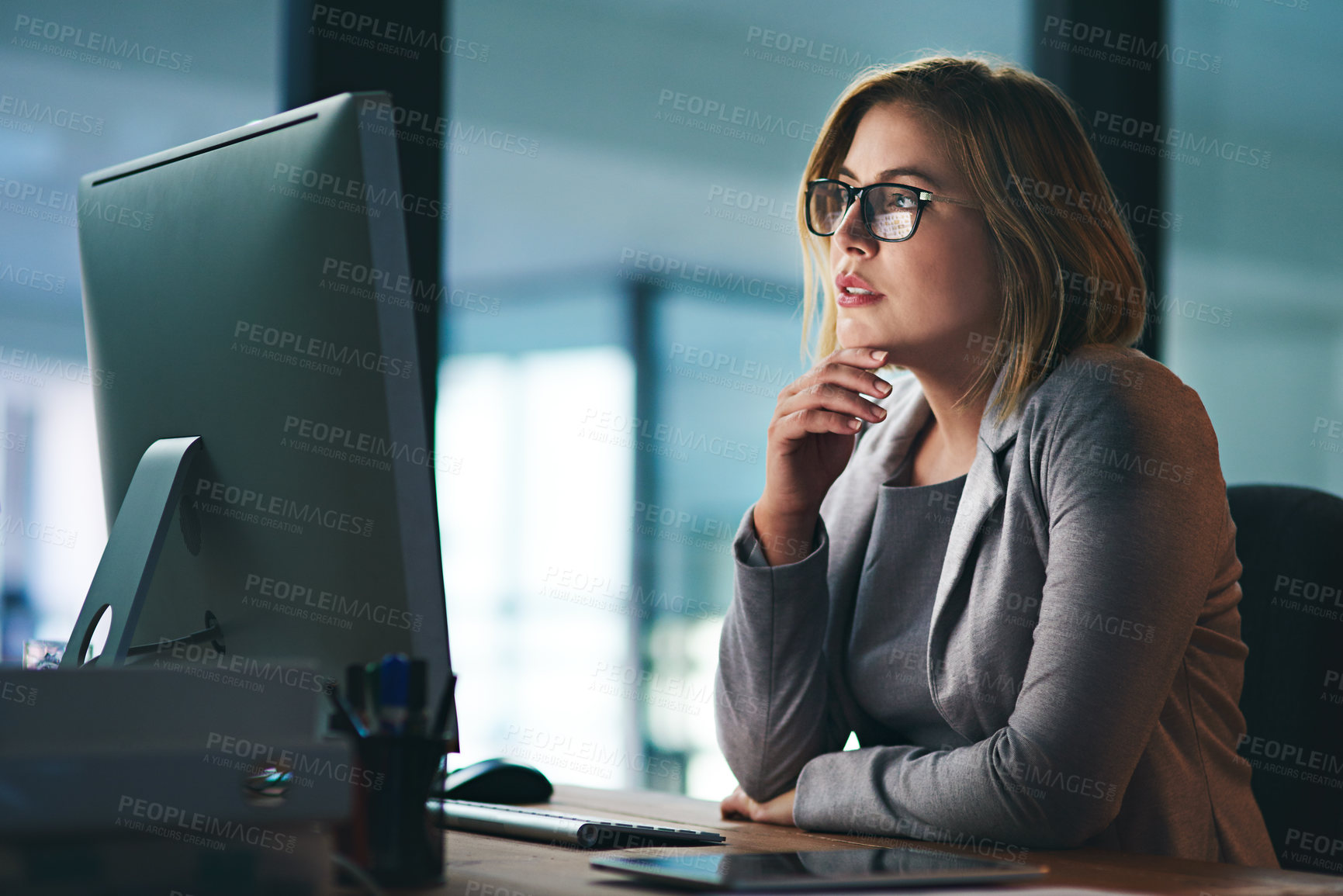 Buy stock photo Computer, problem solving and business woman in office working late on project at night alone. Desktop, professional and female person thinking, focus or solution, planning and reading on deadline.