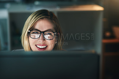 Buy stock photo Shot of a young businesswoman working late on a computer in an office