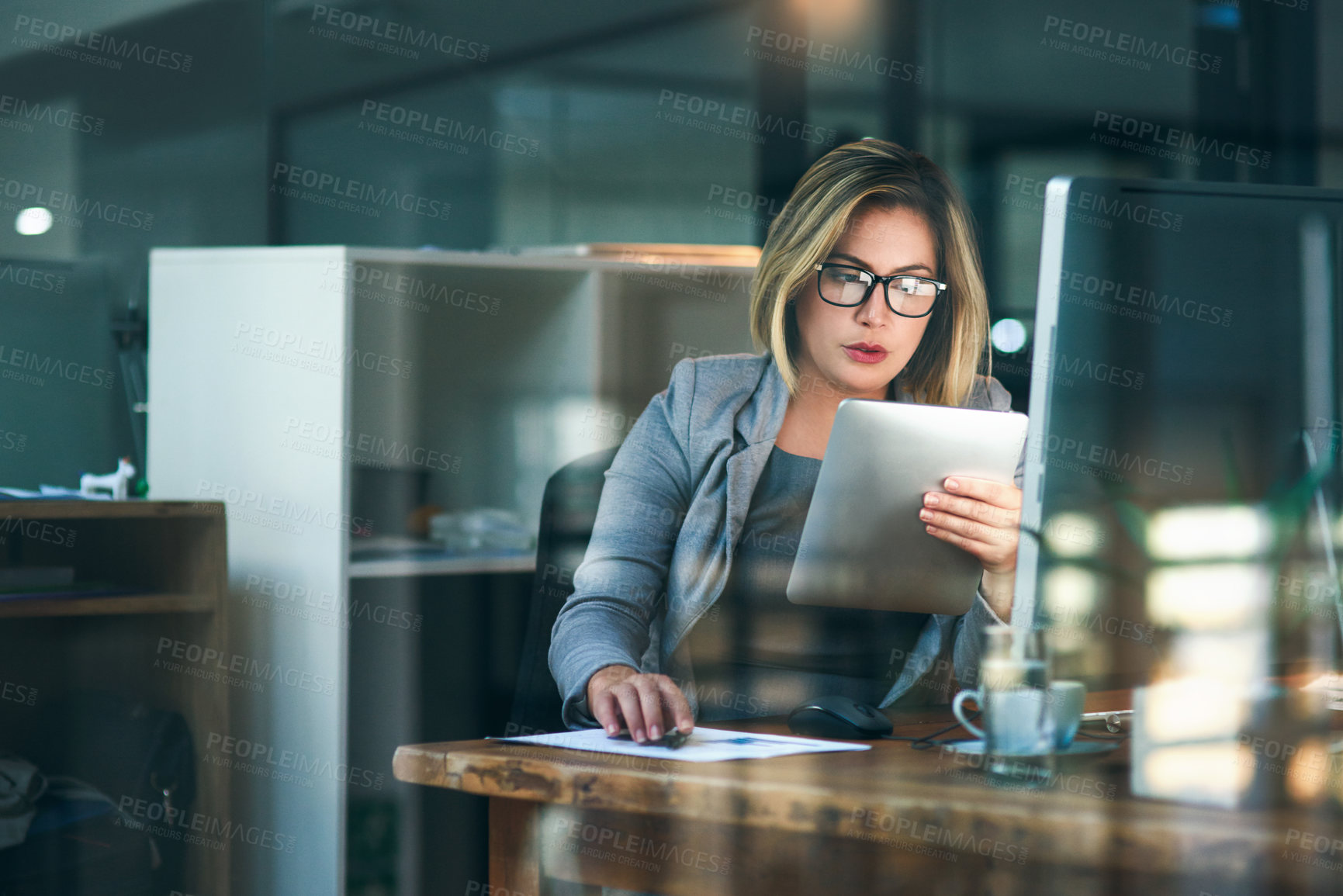 Buy stock photo Woman, office and computer with reading on tablet for email or deadline as project manager in web agency. Female person, business and workplace on tech for planning, ideas as professional for company