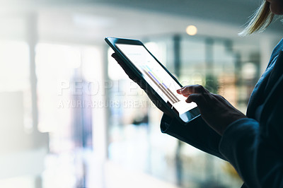 Buy stock photo Closeup shot of a businesswoman working late on a digital tablet in an office