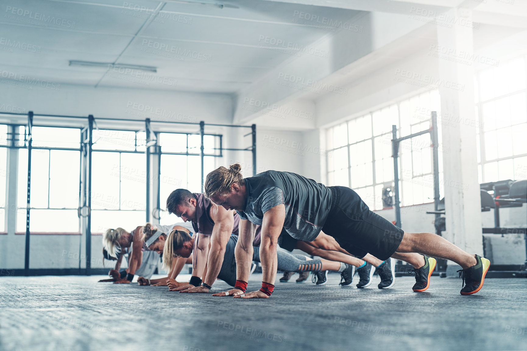 Buy stock photo Shot of an accountability group working out at the gym