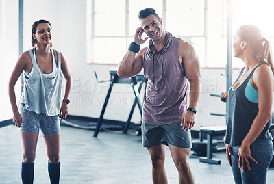 Buy stock photo Shot of three people having a conversation at the gym