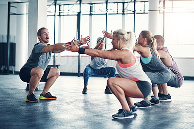 Buy stock photo Shot of a fitness instructor working with a group of people at the gym