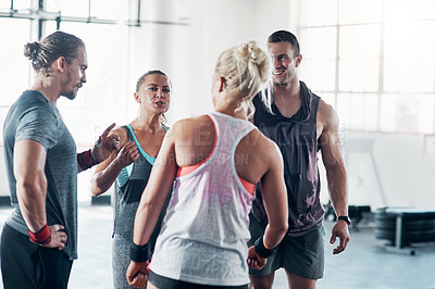 Buy stock photo Cropped shot of a group of people chatting at the gym