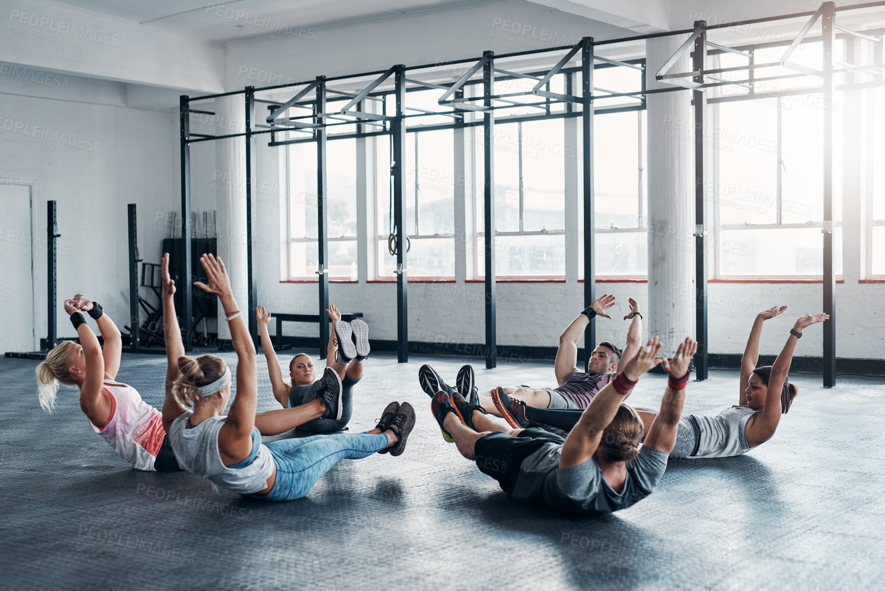 Buy stock photo People, stretching and circle on floor for exercise, workout or training at gym. Fitness, men and women group together for sports challenge, routine and warm up at wellness club for stomach sit up