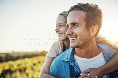 Buy stock photo Cropped shot of a handsome young man piggybacking his girlfriend through the crops on their farm
