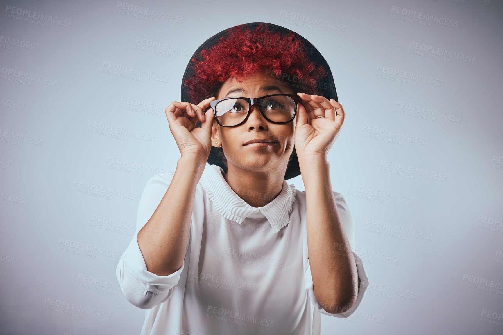 Buy stock photo Studio shot of a beautiful young woman wearing a hat against a grey background