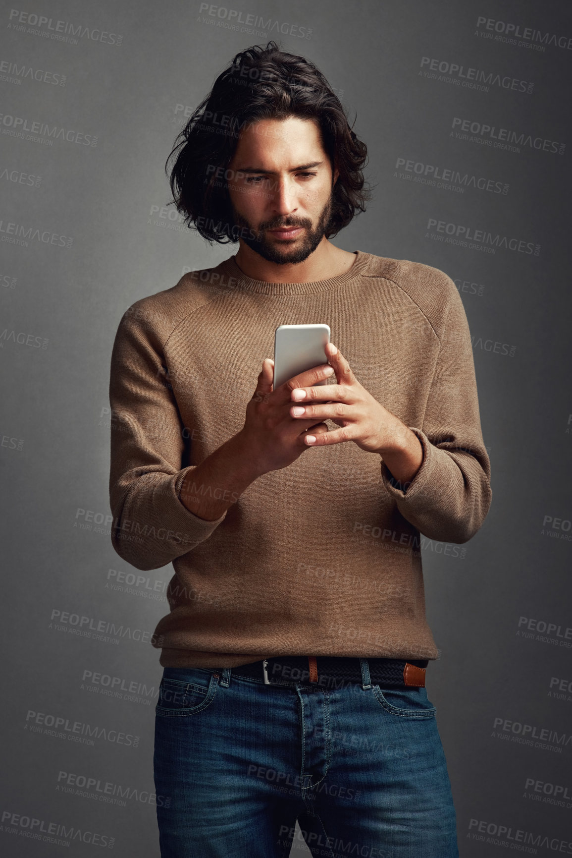 Buy stock photo Communication, man and using phone in studio for reading, blog and online for mobile app. Streaming, male model and social media or internet for networking, connection and typing by dark background