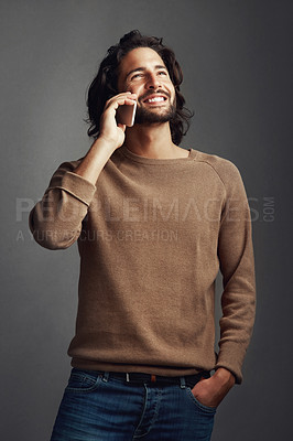 Buy stock photo Man, phone call and smile for conversation with contact, communication and speaking in studio. Male person, happy and mobile hello for discussion, gossip storytelling and network by gray background