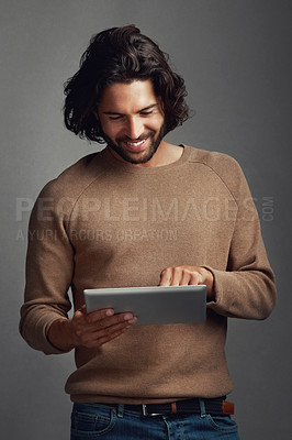 Buy stock photo Tablet, scroll and happy man in studio for social media, dating app and reading email notification. Digital technology, typing and person on website for fashion blog info isolated on gray background