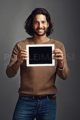 Buy stock photo Portrait, tablet screen and smile of man with mockup in studio isolated on a gray background. Touchscreen, face and male person with marketing, advertising and technology for commercial promotion.