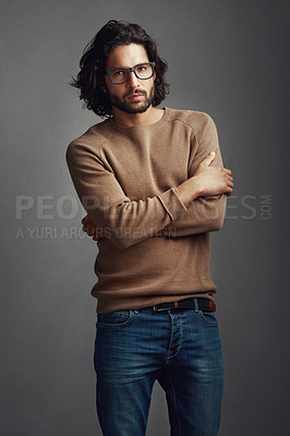 Buy stock photo Fashion, portrait and man in studio with arms crossed for trendy clothes, casual outfit or denim jeans on gray background. Style, cool and model for designer glasses, winter jersey or confidence