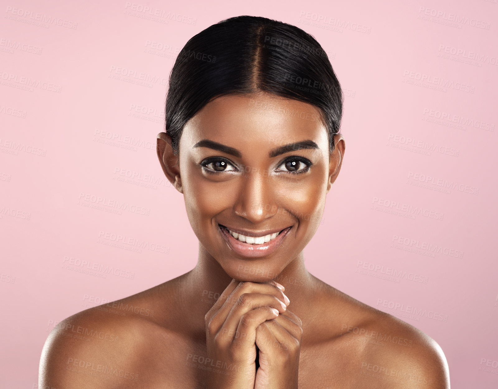 Buy stock photo Face portrait, skincare and smile of woman in studio isolated on a pink background. Natural beauty, aesthetic and Indian female model with makeup, cosmetics and spa facial treatment for healthy skin.