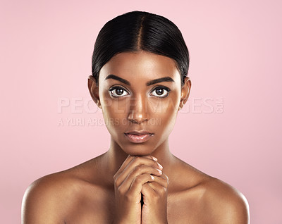 Buy stock photo Face portrait, skincare and serious woman in studio isolated on a pink background. Natural beauty, aesthetic and Indian female model with makeup, cosmetics and spa facial treatment for healthy skin.