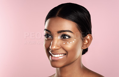 Buy stock photo Thinking, skincare and face of woman with eye cream in studio isolated on pink background mockup. Dermatology, creme cosmetics and happy Indian female model with moisturizer lotion for healthy skin.