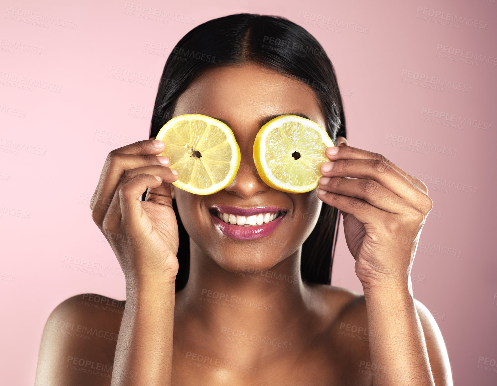 Buy stock photo Face, skincare and smile of woman with orange slices in studio isolated on a pink background. Fruit, natural cosmetics and Indian female model holding food for healthy diet, nutrition or vitamin c.