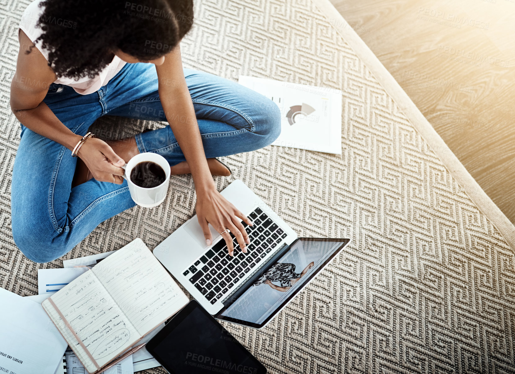 Buy stock photo High angle shot of an unrecognizable young businesswoman working on her laptop in her home office