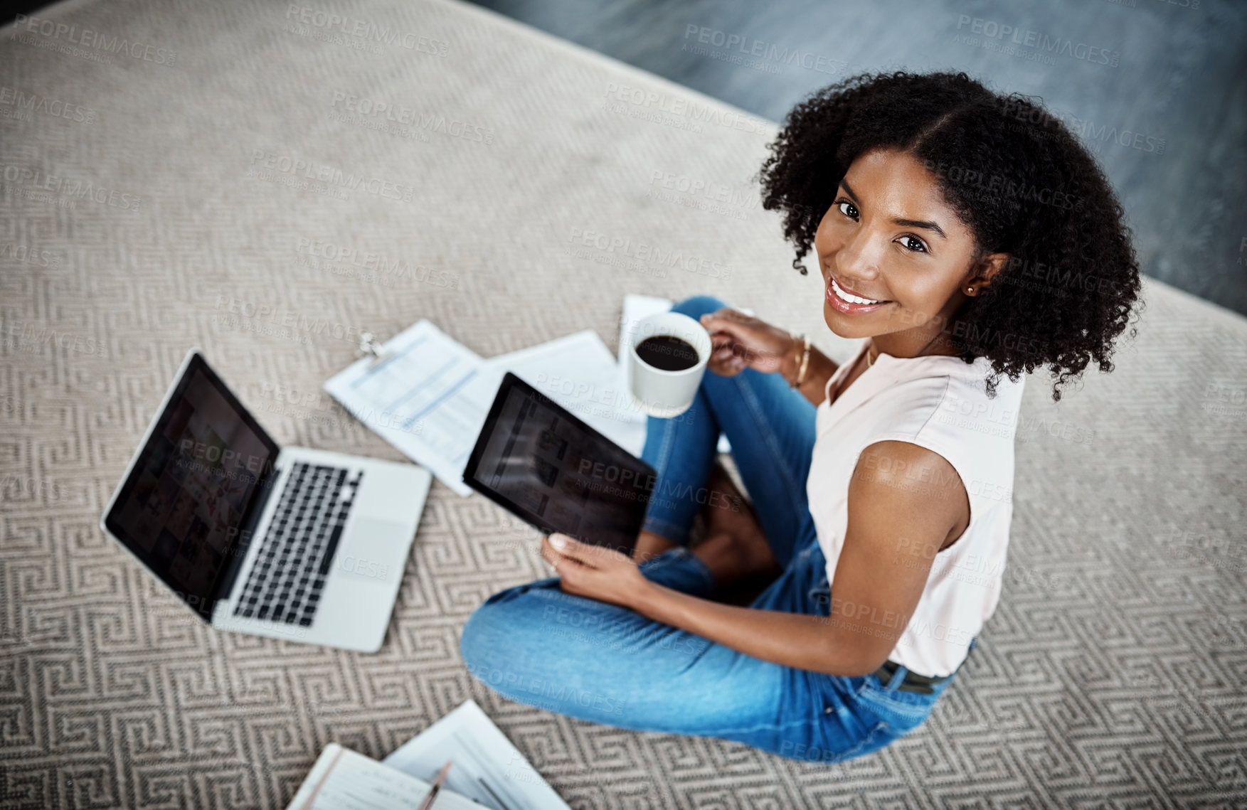 Buy stock photo High angle portrait of an attractive young businesswoman working on her tablet in her home office