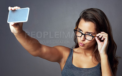 Buy stock photo Glasses, kissing and selfie with influencer woman in studio for social media status post or update. Eyewear, photograph and pouting with confident model on gray background for profile picture