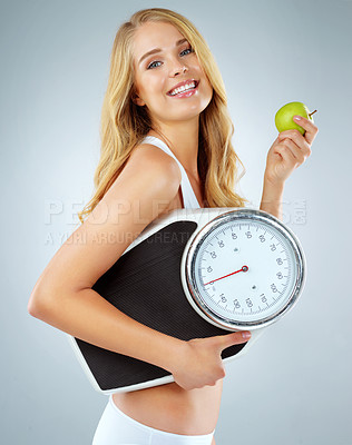 Buy stock photo Woman in portrait, happy with apple and scale, lose weight and healthy food isolated on studio background. Female model with smile, health and diet with organic fruit with happiness and weightloss