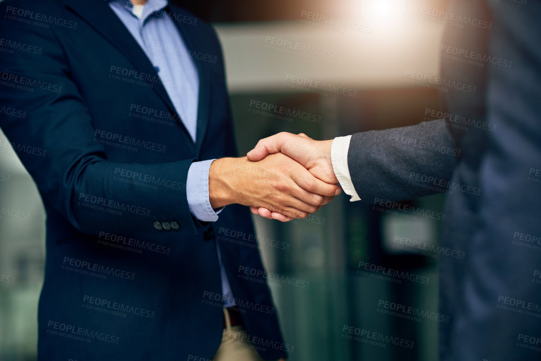 Buy stock photo Cropped shot of two unrecognizable businessmen shaking hands in an office