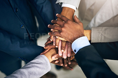 Buy stock photo High angle shot of a group of unrecognizable businesspeople joining their hands together in unity
