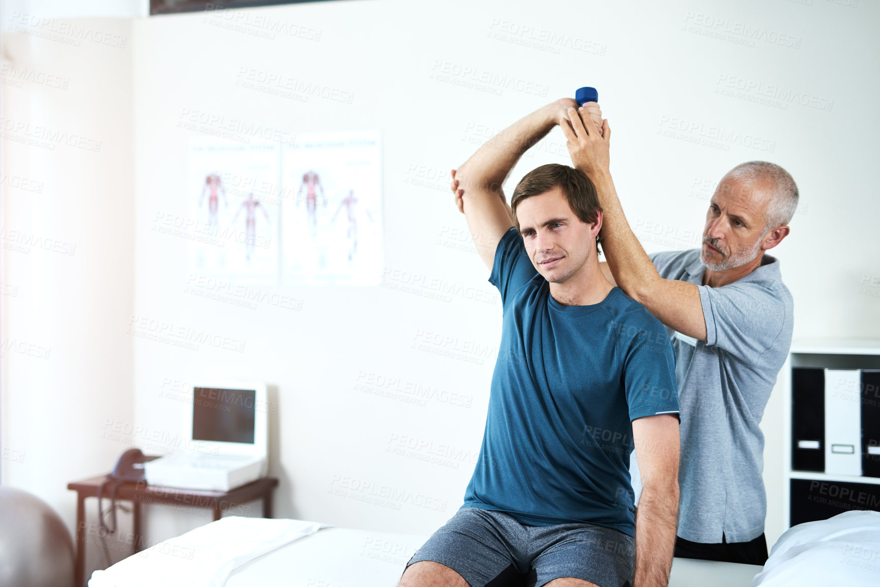 Buy stock photo Man, physiotherapy and dumbbell or lifting arm, physiotherapist and clinic for sport injury recovery. Body wellness, mobility support and client or muscle strength, medical help and assessment