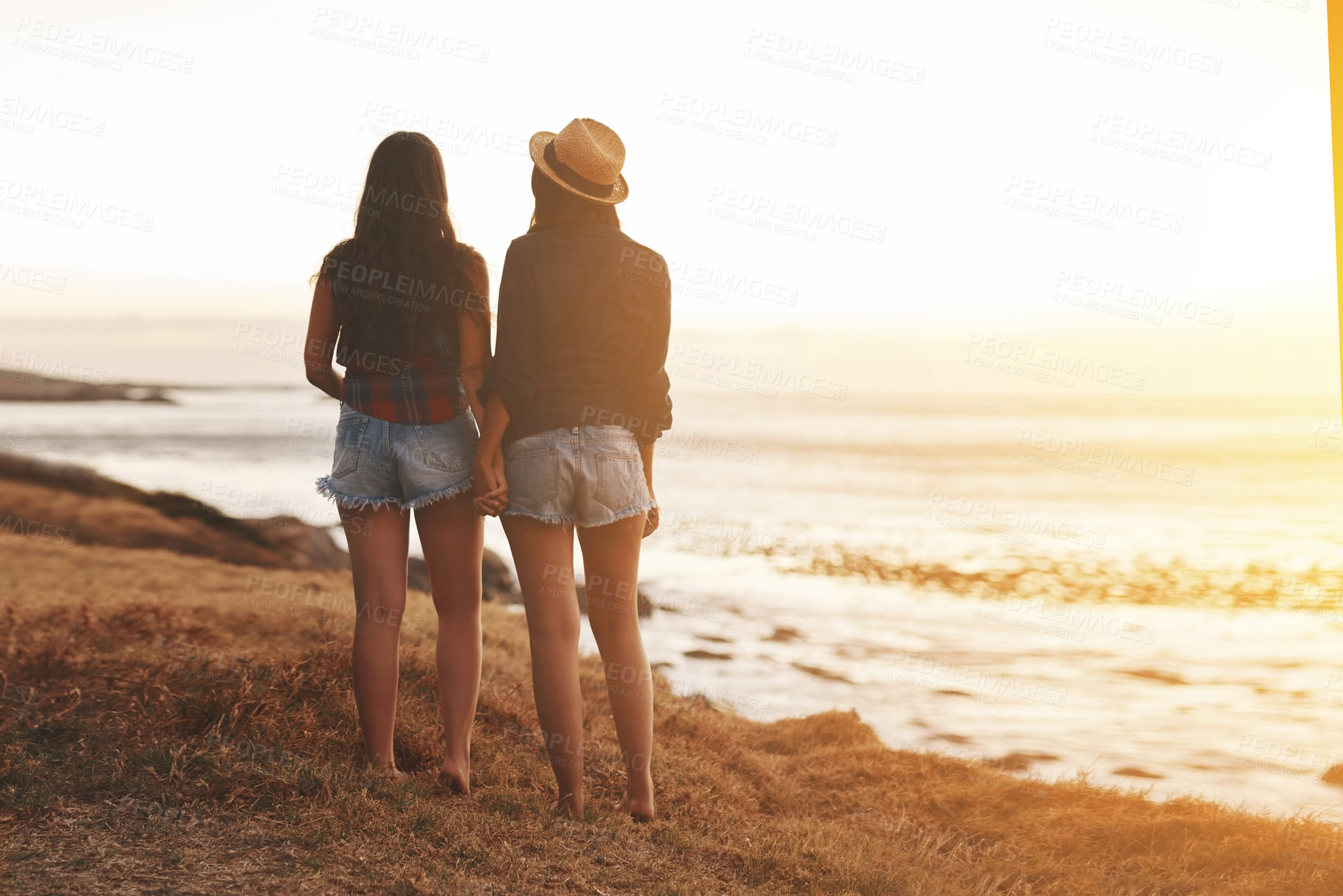 Buy stock photo Travel, holding hands and back of women at beach for holiday, summer vacation and bonding on weekend. Couple of friends, nature and people by ocean for adventure, sunshine and relax together by sea