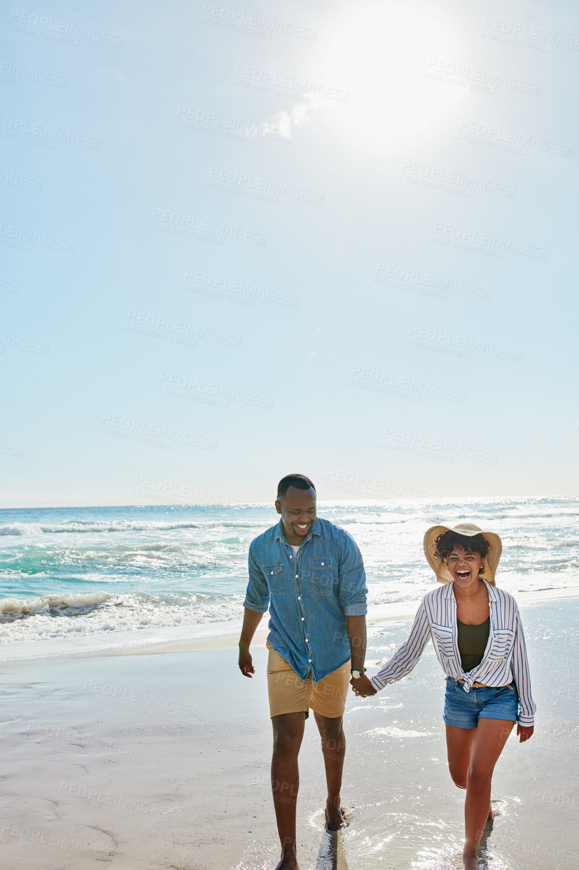 Buy stock photo Happy, laughing and black couple holding hands at the beach for love, freedom and trust in Bali. Travel, smile and black man and woman walking by the ocean during a holiday for a date in summer