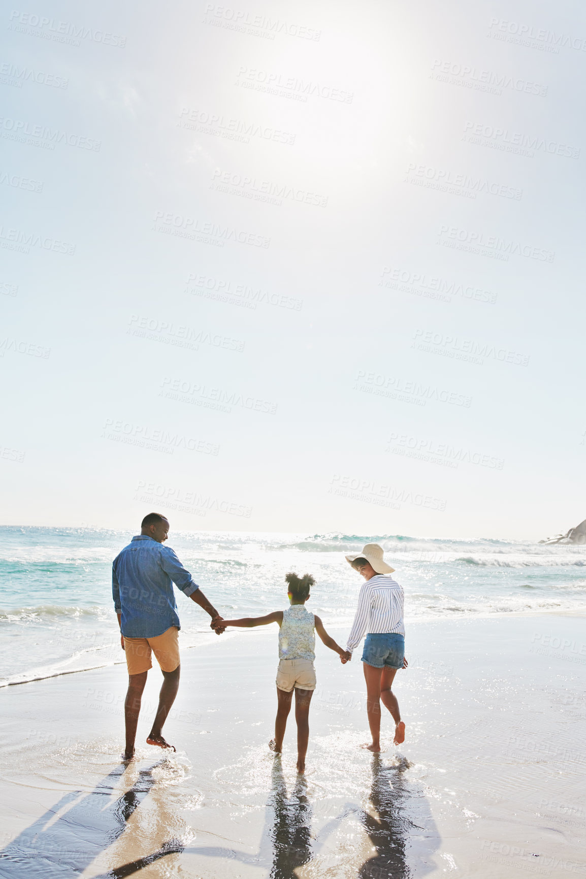 Buy stock photo Beach vacation and couple with child walking in water while holding hands together with love in summer from the back. Nature, ocean and blue sky, black family on tropical island holiday in Maldives.