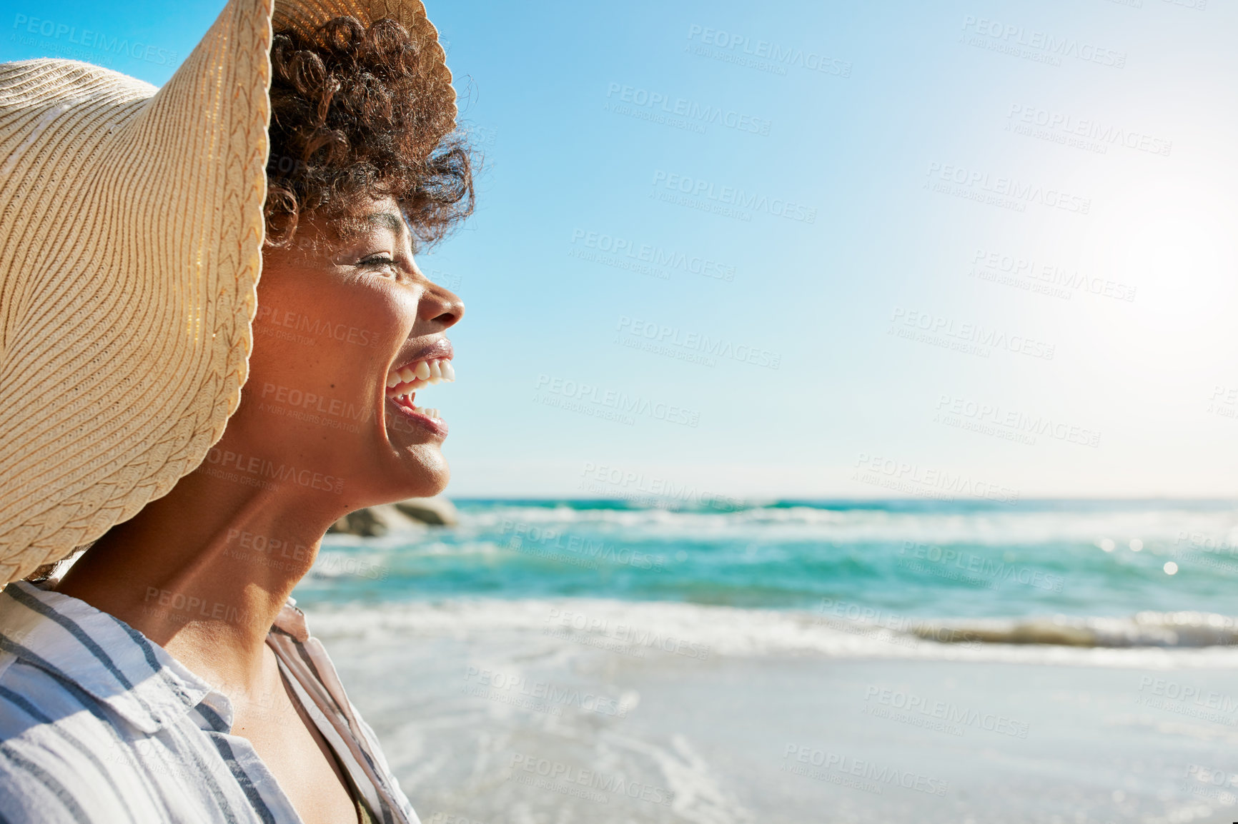 Buy stock photo Shot of a young woman enjoying a day at the beach