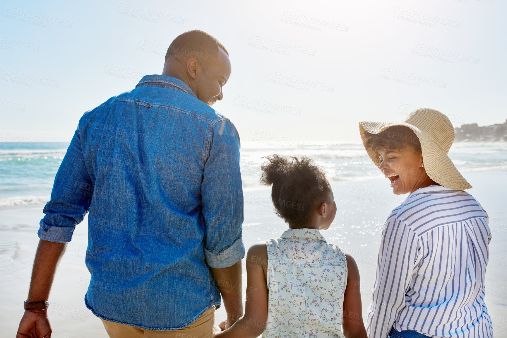 Buy stock photo Black family, beach and walking during summer on vacation or happy holiday laughing and enjoying the scenery at the ocean. Sea, water and parents with daughter, child or kid with childhood freedom