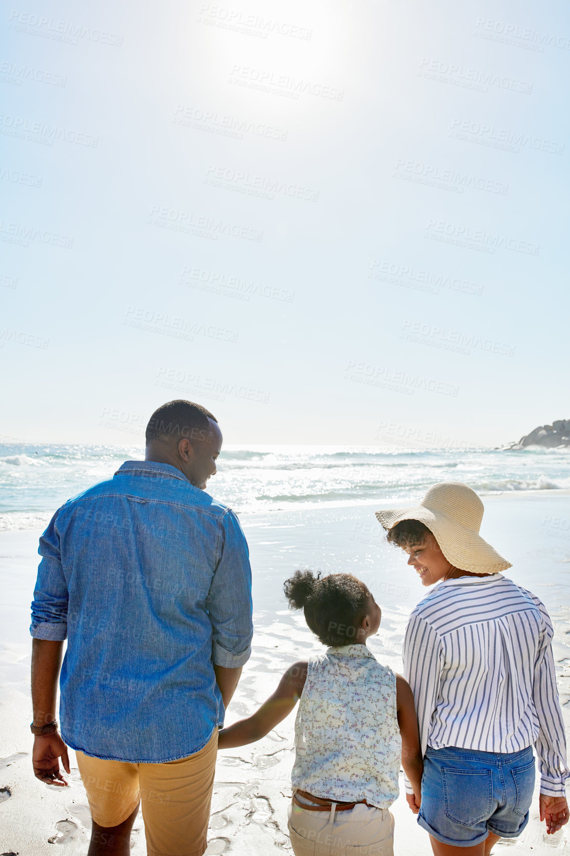 Buy stock photo Black family, back and holding hands with kid on beach for bonding, holiday or outdoor weekend. African mother, father and child walking in sunshine together for fun summer by ocean coast in nature