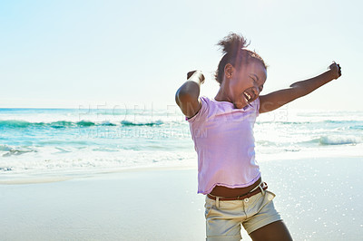 Buy stock photo Shot of an adorable little girl enjoying a day at the beach