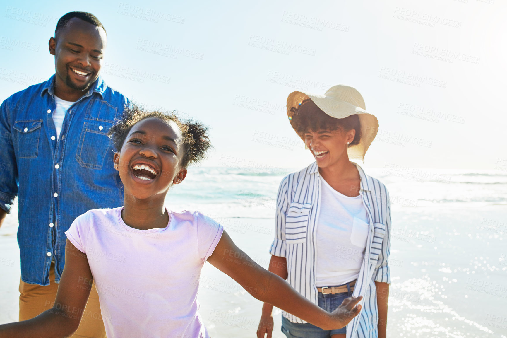 Buy stock photo Relax, travel and happy with black family at beach for summer break, support and tropical vacation. Peace, smile and happiness with parents and daughter playing by the ocean for freedom, sea and care