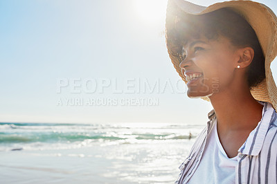 Buy stock photo Shot of a young woman enjoying a day at the beach