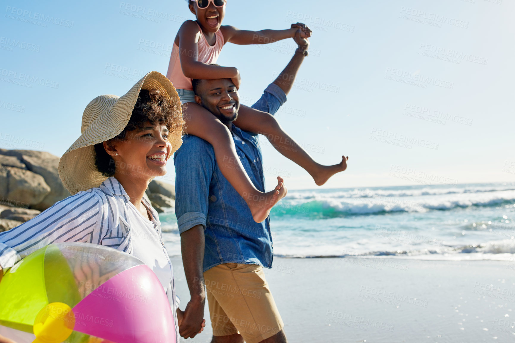 Buy stock photo Happy family, shoulder and walking with daughter on beach for bonding, holiday or outdoor weekend. Mother and father carrying little girl or child for fun summer together by ocean coast in nature